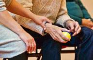 Image of elderly man holding a ball